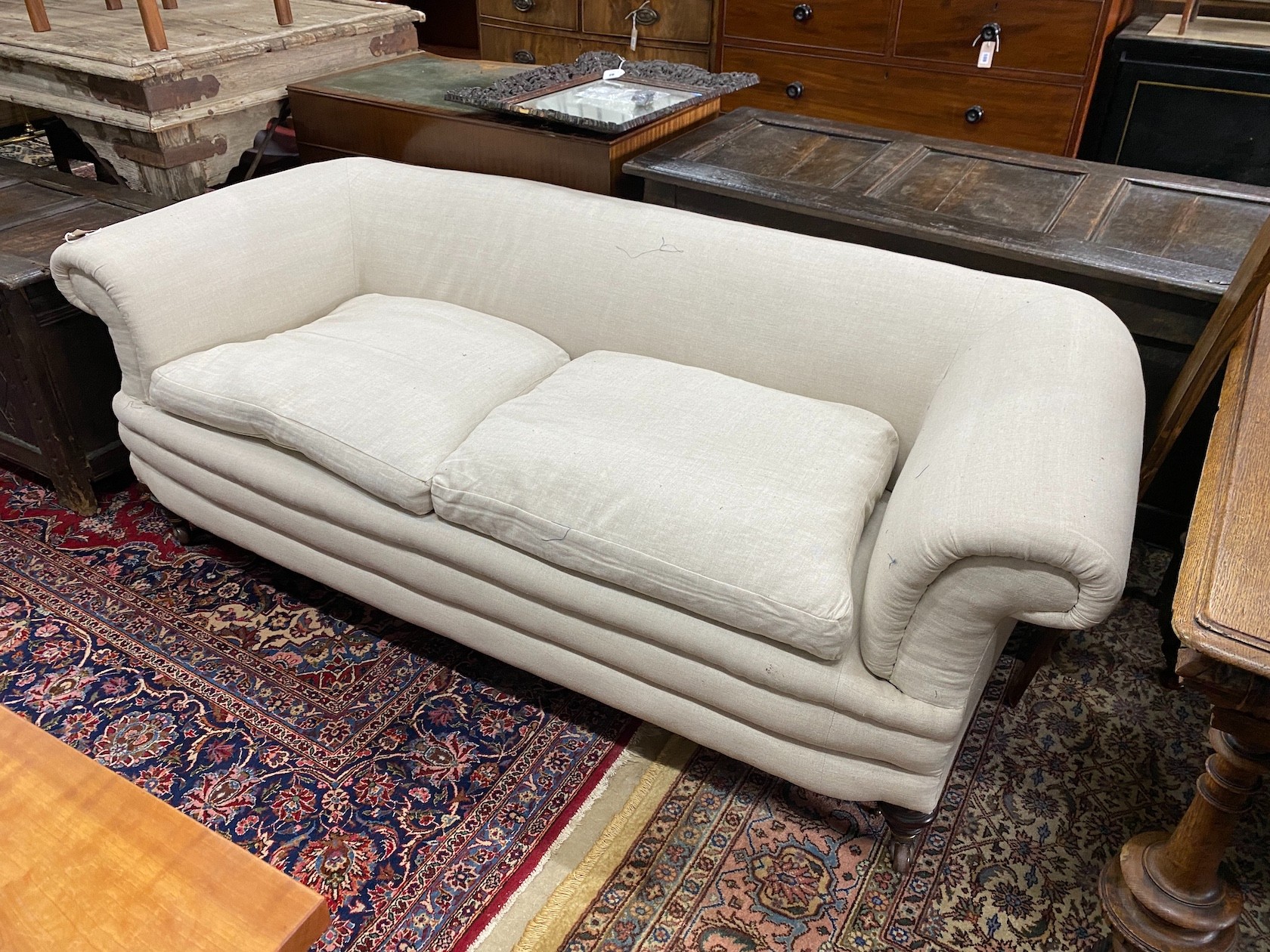 A late Victorian Howard style Chesterfield settee upholstered in natural fabric, length 190cm, depth 78cm, height 66cm
